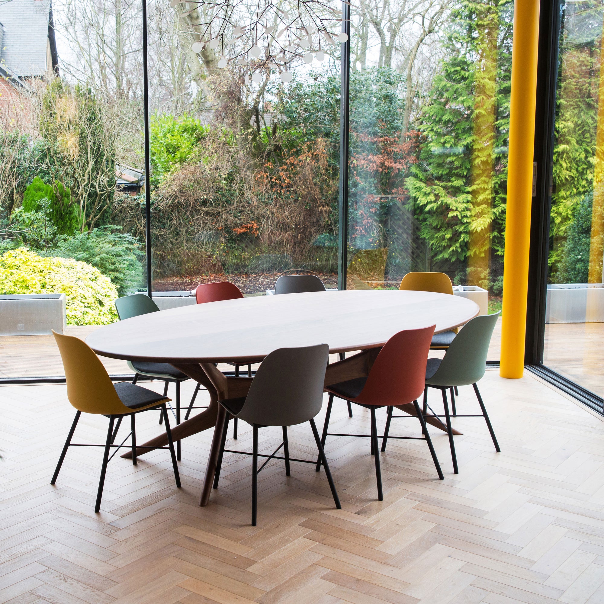 Walnut dining table with sculpted base