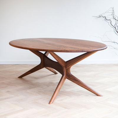 Walnut dining table with sculpted base