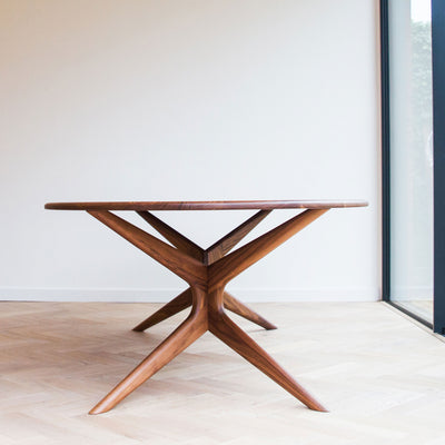 Walnut dining table with sculpted base